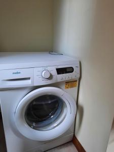 a washing machine and a washer in a room at Pacha Home By A.M.A in San Carlos de Bariloche