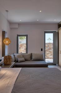 a living room with a couch and two windows at Clementina Paros in Kampos Paros