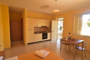 a kitchen with a table and a dining room at Medimare Residence Club in Patti