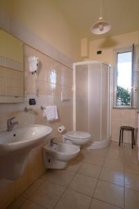 a bathroom with a sink and a toilet and a shower at Medimare Residence Club in Patti