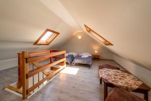 a attic room with a bed and a staircase at Apartamenty Gromada Międzyzdroje in Międzyzdroje
