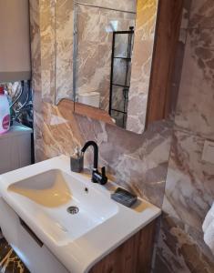 a bathroom with a sink and a mirror at Antik House İznik in İznik