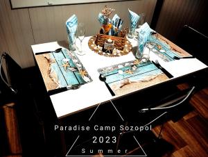 a table topped with a table centerpiece with a tiara at Paradise Camp Sozopol in Sozopol
