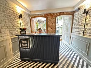 a woman sitting at the counter of a hotel lobby at World House Boutique Hotel Galata in Istanbul