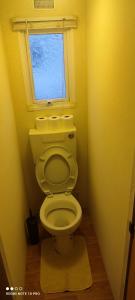 a small bathroom with a toilet with a window at Beachside, Family-friendly, WiFi, 6 berth Caravans in Ingoldmells +42 photos