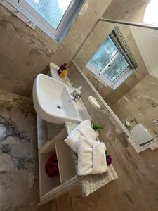 a bathroom with a sink and a mirror at Villa Katia in Asprovalta