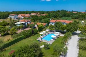 an aerial view of a house with a pool and umbrellas at Apartments Grota in Poreč