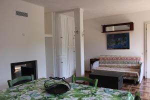 a room with a table with a bed in the background at Agriturismo la Lecciola in Rio nellʼElba