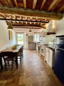 a large kitchen with a table and a dining room at Intero alloggio campagna Lucca in Capannori +51 photos