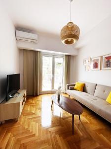 a living room with a couch and a table at Plaka athens 1 bedroom 4 persons apartment by MPS in Athens