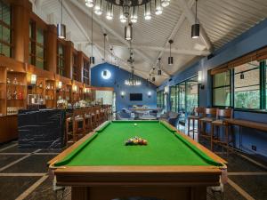 a pool table in a room with a bar at Angsana Oasis Spa & Resort in Yelahanka