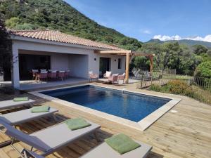a villa with a swimming pool and a house at Résidence La Plage in Propriano