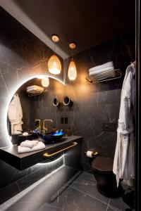 a bathroom with a sink and a mirror at Ushuaia Playa Xemxija Boutique Hotel in St Paul's Bay