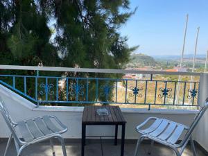 two chairs and a table on a balcony at Villa Panorama in Selcuk