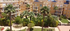 an aerial view of a large apartment complex with palm trees at Aguamarina, las Calitas, frente al mar in Orihuela Costa
