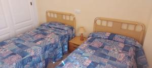 two beds sitting next to each other in a bedroom at Aguamarina, las Calitas, frente al mar in Orihuela Costa +23 photos