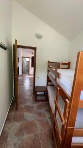 a bedroom with two bunk beds and a tile floor at House in the Mountains near Budva in Budva