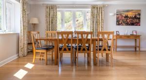 a dining room with a wooden table and chairs at Cunsey Lodge in Far Sawrey