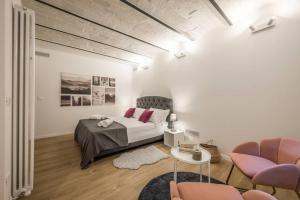 a bedroom with a bed and a table and chairs at Santo Stefano Apartment with private Garden in Bologna