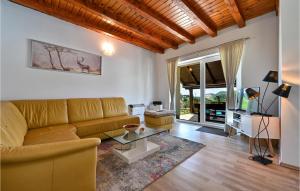 a living room with a couch and a table at Beautiful Home In Pregrada With Kitchen in Pregrada