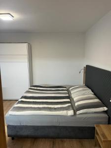 a bed with two pillows on it in a room at Apartmány u pláže Lipna - Riviera in Lipno nad Vltavou