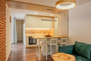 a kitchen with a table and chairs in a room at Zuzo flat Stare Koliesko 96 in Belá