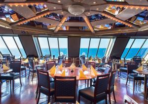 a dining room with tables and chairs and the ocean at Viking Line ferry Viking Cinderella - Cruise Stockholm-Helsinki-Stockholm in Stockholm