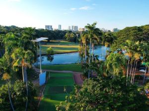 an aerial view of a golf course with palm trees at Top End Getaway - Luxury Home in Palmerston