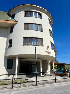 a large white building with a sign in front of it at MyMara, Apartmán Beťo in Bešeňová