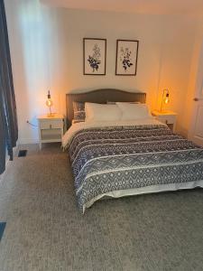 a bedroom with a large bed with two night stands at Luxurious town house with x2 Cars Garage no01 in Cambridge