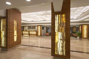 a lobby with wooden columns in a building at Ramada by Wyndham Bahrain in Manama