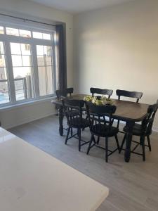 a dining room with a wooden table and chairs at Luxurious town house with x2 Cars Garage no01 in Cambridge