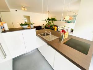 een keuken met witte kasten en een wastafel bij Large 3 bedrooms in Center with Terraces & Parking - ROL1 in Luxemburg