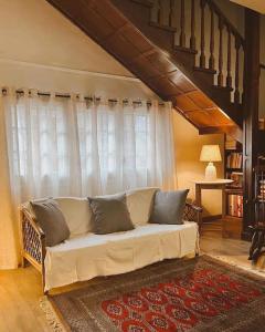 a living room with a white couch in front of a window at Casa Boixareu in La Pobla de Segur