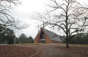 a church with a tree in front of it at Budget Inn Jonesboro in Jonesboro