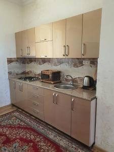a kitchen with a sink and a counter top at Гостевой дом у Эмзара in Batumi