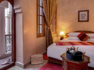Ein Bett oder Betten in einem Zimmer der Unterkunft Marrakech Riads, Angsana Heritage Collection