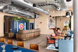 a restaurant with tables and chairs and a bar at Hyatt Centric Cambridge in Cambridge