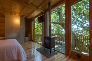 a bedroom with a bed and a screened in porch at Cabanas de Apriscos in A Coruña