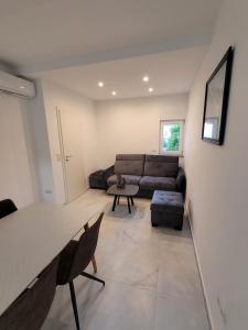 a living room with a couch and a table at Harizma in Primošten