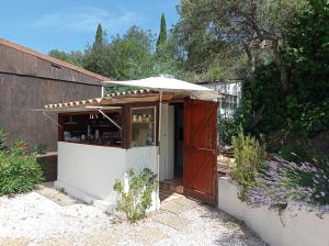 a small kiosk with an umbrella in a garden at HOME Ste Maxime in Le Muy