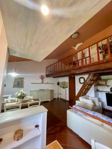 a living room with a staircase and a dining room at Amazing house 10 min by car from the beach in Olbia