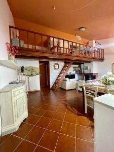 a kitchen and living room with a loft at Amazing house 10 min by car from the beach in Olbia