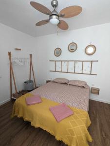 a bedroom with a bed with two towels on it at Ático con terraza frente al mar Playa Zapillo in Almería