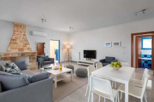 a living room with a couch and a table at Aegean View Estates in Faliraki