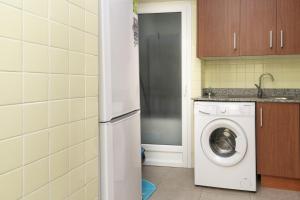 a kitchen with a washing machine in a kitchen at Provence, 5º-18 in Cullera