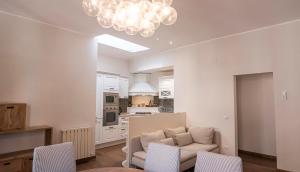 City Center - Alba di Perugia في بيروجيا: غرفة معيشة مع أريكة وثريا