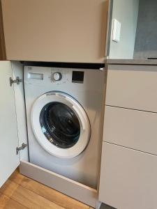 a washer and dryer in a small room at Palanga Studios in Palanga