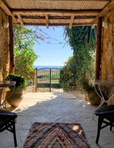 an entrance to a patio with a view of the ocean at Khanfous Retreat in Asilah