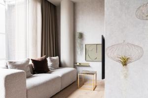 a living room with a couch and a window at 348 Suites Short Stay in The Hague